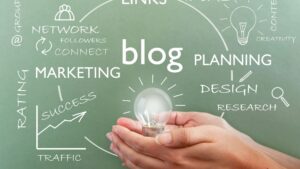 Hands holding glowing light bulb in front of chalkboard with blog, planning, marketing and SEO strategy terms